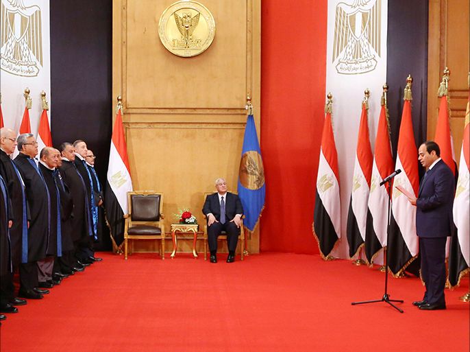 President-elect Abdel Fattah al-Sisi swears in as President in front of Egypt's interim head of state Adly Mansour (C) and constitutional court members in Cairo June 8, 2014 in this handout provided by The Egyptian Presidency. Former army chief Sisi was sworn in as president of Egypt on Sunday in a ceremony with low-key attendance by Western allies concerned by a crackdown on dissent since he ousted Islamist leader Mohamed Mursi last year. REUTERS/The Egyptian Presidency/Handout via Reuters (EGYPT - Tags: POLITICS IMAGES OF THE DAY) NO SALES. NO ARCHIVES. FOR EDITORIAL USE ONLY. NOT FOR SALE FOR MARKETING OR ADVERTISING CAMPAIGNS. THIS IMAGE HAS BEEN SUPPLIED BY A THIRD PARTY. REUTERS IS UNABLE TO INDEPENDENTLY VERIFY THE AUTHENTICITY, CONTENT, LOCATION OR DATE OF THIS IMAGE. IT IS DISTRIBUTED, EXACTLY AS RECEIVED BY REUTERS, AS A SERVICE TO CLIENTS