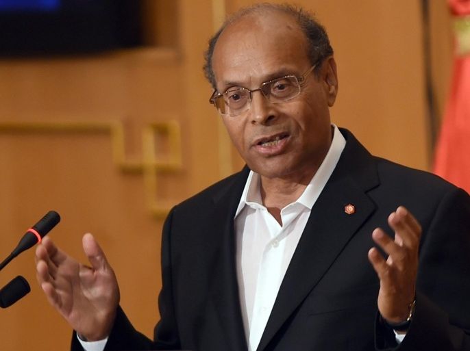 Tunisian President Moncef Marzouki speaks during a ceremony to unveil the 'truth and dignity commission' on June 9, 2014, in the capital Tunis. The commission formed to identify and compensate victims abused under decades of dictatorship, is made up of human rights activists, representatives of victim groups, opponents of Ben Ali and judges, and is tasked iswith identifying voluntary homicide, rape, extrajudicial killings and torture, as well as economic crimes and corruption. AFP PHOTO/FETHI BELAID