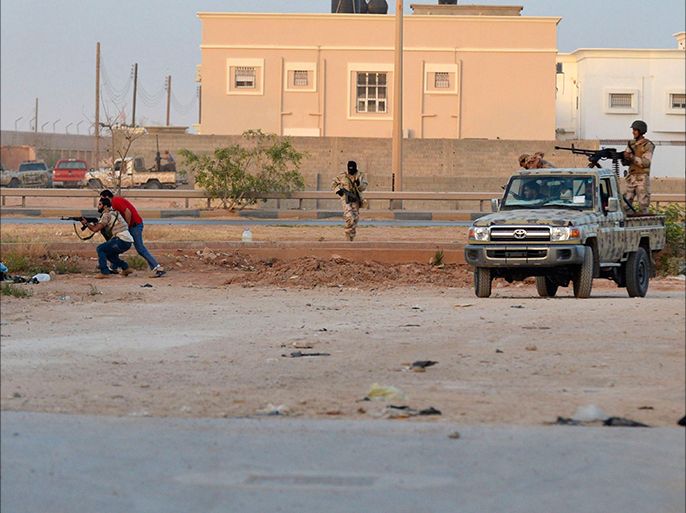 Irregular forces loyal to former army general Khalifa Haftar take their positions with their weapons during clashes with Islamist militants in the eastern city of Benghazi June 2, 2014. Eight people were killed and 15 wounded when fighting broke out on Monday between the Libyan army and Islamist militants in Benghazi, medical sources said. The Ansar al-Sharia militant group attacked a camp on Monday belonging to army special forces, residents there said. Forces of the renegade general fighting Islamists later joined the battle, using combat helicopters, they added. REUTERS