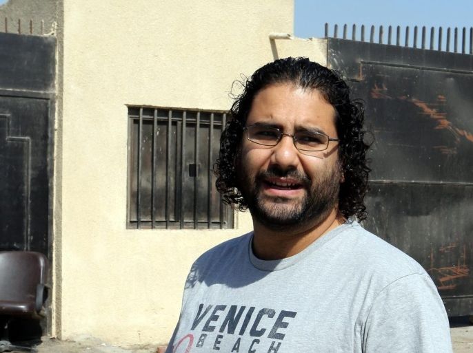 Egyptian activist Alaa Abdel-Fatah (C) arrives to attend a trial in Cairo, Egypt, 11 June 2014. An Egyptian court handed down a 15-year jail term to the prominent pro-democracy campaigner Alaa Abdel-Fattah on 11 June, on charges of organizing an unauthorized protest. It was the latest such conviction for a pro-democracy activist who had been prominent in the 2011 ouster of former president Hosni Mubarak. Abdel-Fattah was also charged with attacking a police officer and stealing his walkie-talkie; inciting riot and damaging public property during a protest he staged in November against the referral of civilians to military courts.
