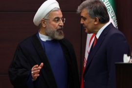 Turkey's President Abdullah Gul, right, and his Iranian counterpart Hassan Rouhani speak during a signing ceremony for the agreements between their countries at the Cankaya Palace in Ankara, Turkey, Monday, June 9, 2014. Rouhani is in Turkey for a two-day state visit. (AP Photo)