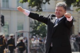 Ukrainian President Petro Poroshenko lifts his arms in greeting after the inauguration ceremony in Sophia Square in Kiev, Ukraine, Saturday, June 6, 2014. Petro Poroshenko took the oath of office as Ukraine’s president Saturday, assuming leadership of a country mired in a violent uprising and economic troubles. (AP Photo/Sergei Chuzavkov)