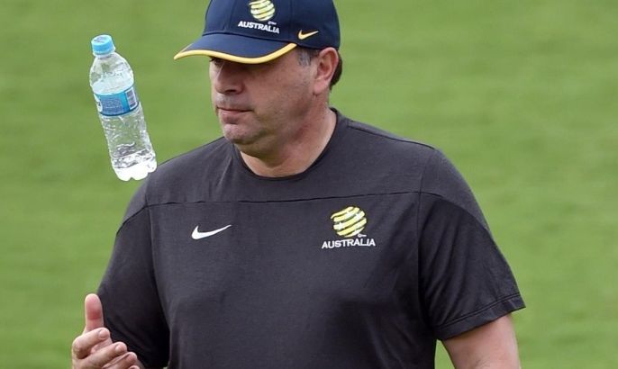 Australian Socceroos football coach Ange Postecoglou tosses his water bottle during the team's first training session in Vitoria on May 30, 2014, as they prepare for the 2014 FIFA World Cup in Brazil. AFP PHOTO/William WEST
