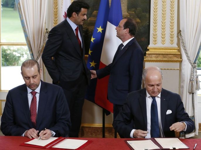 Emir of Qatar, Sheikh Tamim bin Hamad Al Thani, back left, and French President Francois Hollande, back right, speak as they attend a signature of agreements ceremony with French Foreign Affairs Minister Laurent Fabius, right, and Qatar's Minister of Commerce Sheik Ahmad Bin Jassem bin Mohammed Al Thani, left, at the Elysee Palace in Paris, Monday, June 23, 2014. French President Francois Hollande hosts the Emir of Qatar, Sheikh Tamim bin Hamad Al Thani, and signs a raft of business deals. The leaders are expected to discuss violence in Iraq and Syria, where France and Qatar have supported the opposition to Syrian President Bashar Assad. (AP Photo/Ian Langsdon, Pool)
