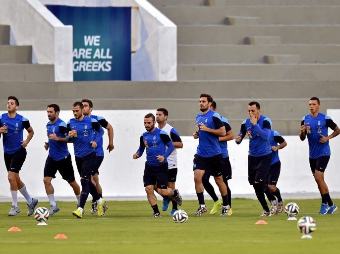 Greece's footballers warm up during a training session in Aracaju, Brazil on June 26, 2014, ahead their 2014 FIFA World Cup match against Costa Rica. AFP PHOTO / ARIS MESSINIS