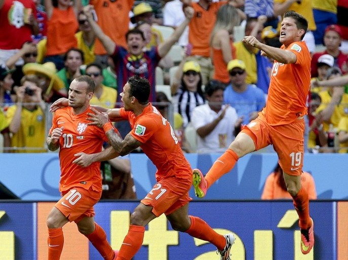 Netherlands' Wesley Sneijder (10) celebrates with teammates Memphis Depay and Klaas-Jan Huntelaar (19) after scoring his side's first goal during the World Cup round of 16 soccer match between the Netherlands and Mexico at the Arena Castelao in Fortaleza, Brazil, Sunday, June 29, 2014. (AP Photo/Felipe Dana)