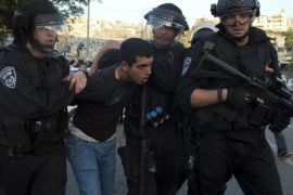 Israeli security forces arrest an Arab Israeli protester during clashes following a rally in solidarity with Palestinian prisoners held in Israeli jails and against Israeli army's operation to search for the three Israeli missing teenagers on June 27, 2017 in the northern Israeli town of Umm al-Faham. After the teens disappeared while hitchhiking in the West Bank, the army launched a vast hunt for them focusing on the Hebron area, detaining hundreds of Palestinians. AFP PHOTO/AHMAD GHARABLI
