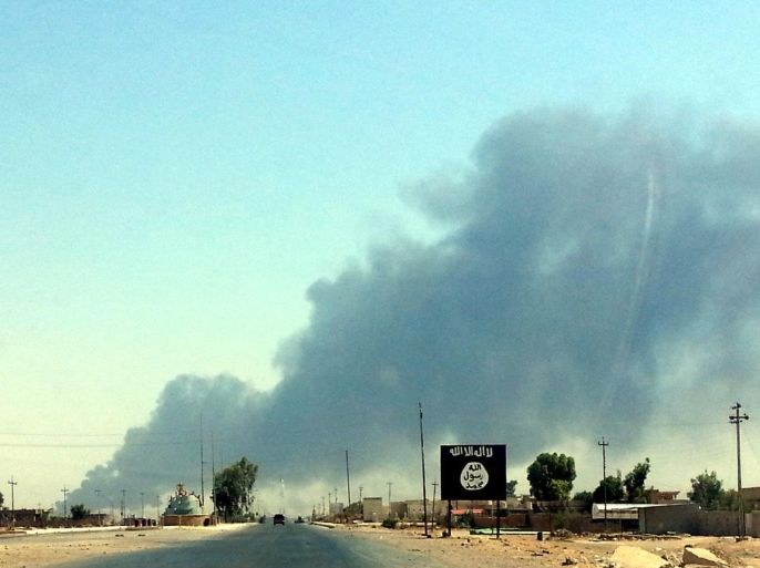 Smoke rises from the the Baiji oil refinery in northern Iraq, 19 June 2014. Workers were evacuated from Iraq's key Baiji refinery, local sources said, as it remained unclear who was actually in control of the plant which accounts for almost a third of the country's refining capacity. Baiji has been the scene of intermittent fighting since the jihadist Islamic State in Iraq and the Levant (ISIL) launched its attack against Iraqi government forces last week, seizing the northern city of Mosul and a string of towns stretching south towards Baghdad.