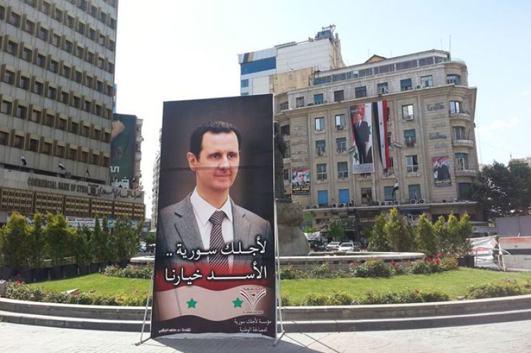 إعلانات المرشح للرئاسة بشار الأسد في دوار المحافظة وسط العاصمة دمشق.jpg