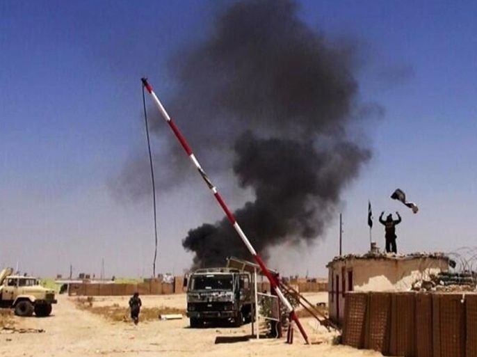 This image posted on a militant news Twitter account on Thursday, June 12, 2014 shows militants from the al-Qaida-inspired Islamic State of Iraq and the Levant (ISIL) people raising their flag at the entrance of an army base in Ninevah Province. Iraq. Fresh gains by insurgents, spearheaded by fighters from the al-Qaida-inspired Islamic State of Iraq and the Levant, come as Prime Minister Nouri al-Maliki's Shiite-led government struggles to form a coherent response after militants overran the country's second-largest city of Mosul, Saddam Hussein's hometown of Tikrit and smaller communities, as well as military and police bases — often after meeting little resistance from state security forces.(AP Photo/albaraka_news)