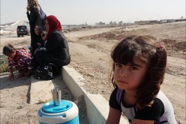 A young Iraqi girl, displaced from the village of Mansuriya in the Diyala province north of Baghdad, where fighting with militant jihadists has been raging, sits on the side of a road on June 27, 2014 as she heads with her family to the ethnically mixed northern Iraqi city of Kirkuk to take refuge. Iraqi Kurdish leader Massud Barzani said there was no going back on autonomous Kurdish rule in Kirkuk and other towns now defended against Sunni militants by Kurdish fighters. AFP PHOTO / MARWAN IBRAHIM
