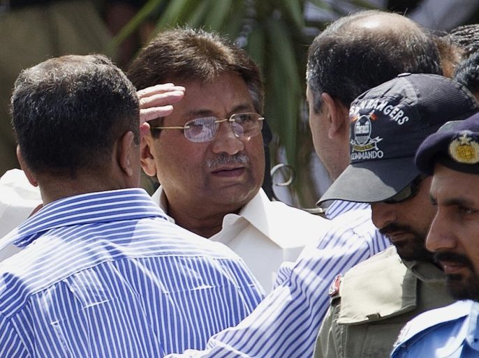 FILE - In this April 12, 2013 file photo, Pakistan's former President and military ruler Pervez Musharraf, center, gestures as he leaves the High Court building in Islamabad, Pakistan. A defense lawyer for Musharraf said Friday, Jan. 31, 2014, that a Pakistani court hearing his high treason case rejected a request that he be allowed to go abroad for treatment. (AP Photo/B.K. Bangash, file)