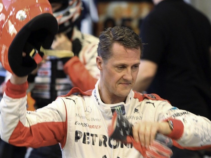 FILE - This is a Sunday, Dec. 16, 2012. file photo of Michael Schumacher of Germany as he holds a helmet after a test drive prior to the Race Of Champions at Rajamangala national stadium in Bangkok, Thailand. Schumacher's manager says the Formula One great is no longer in a coma and has left a French hospital where he had been receiving treatment since a skiing accident in December. Manager Sabine Kehm says in a statement Monday, June 16, 2014, that Schumacher has left the hospital in Grenoble "to continue his long phase of rehabilitation." The statement did not say where the seven-time F1 champion was taken or give any details of his condition. (AP Photo/Apichart Weerawong, File)