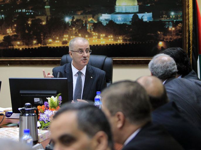 Palestinian Prime Minister, Rami Hamdallah talks during the first cabinet meeting of the new Palestinian unity government in the West Bank city of Ramallah on June 3, 2014. Under terms of the agreement, Hamas and Fatah, which dominates the West Bank administration, worked together to formulate an interim government of independents which will prepare for elections within the next six months. AFP PHOTO/ ABBAS MOMANI