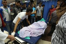 The body of 26 year-old Ahmed Abu Shino, who was allegedly killed by Israeli soldiers at Al Ein Refugee Camp, is brought to Rafedya Hospital Morgue near Nablus, the West Bank, 22 June 2014. According to Palestinian medical sources, Israeli soldiers killed Abu Shino near his home after they raided the refugee camp in search of three missing Israeli teenagers. Raids have been taking place since the teens went missing on June 12 from a common hitchhike stop near a settlement block south of Jerusalem. Neither Hamas nor any other group has claimed responsibility for the disappearances.