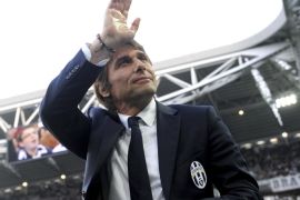 FILE - In this April 7, 2014 file photo, Juventus coach Antonio Conte waves to supporters during a Serie A soccer match between Juventus and Livorno at the Juventus stadium, in Turin, Italy. On Tuesday, July 15, 2014 Juventus and Conte announced the coach's contract terminated by mutual consent. (AP Photo/Massimo Pinca, files)