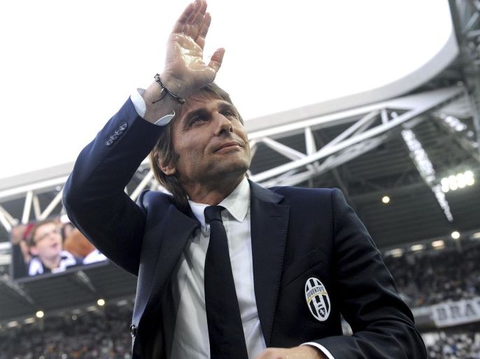 FILE - In this April 7, 2014 file photo, Juventus coach Antonio Conte waves to supporters during a Serie A soccer match between Juventus and Livorno at the Juventus stadium, in Turin, Italy. On Tuesday, July 15, 2014 Juventus and Conte announced the coach's contract terminated by mutual consent. (AP Photo/Massimo Pinca, files)