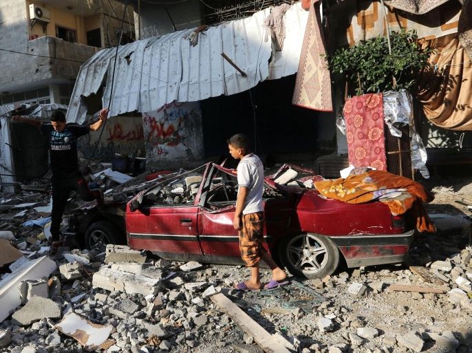Palestinians inspect the rubble of a house after it was hit by an Israeli missile strike in Gaza City, Thursday, July 10, 2014. Israel dramatically escalated its aerial assault in Gaza Thursday, hitting hundreds of Hamas targets as its missile defense system once again intercepted rockets aimed at the country’s heartland. (AP Photo/Hatem Moussa)