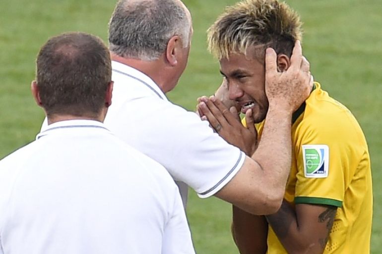 Brazil's forward Neymar cries as he celebrates with Brazil's coach Luiz Felipe Scolari after Brazil won their match against Chile in a penalty shoot out after extra-time in the Round of 16 football match between Brazil and Chile at The Mineirao Stadium in Belo Horizonte during the 2014 FIFA World Cup on June 28, 2014. AFP PHOTO / ODD ANDERSEN