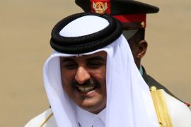 Qatar's Emir Sheikh Tamim bin Hamad al-Thani smiles as he is welcomed upon arriving at Khartoum Airport for an official visit April 2, 2014. REUTERS/Mohamed Nureldin Abdallah (SUDAN - Tags: POLITICS)
