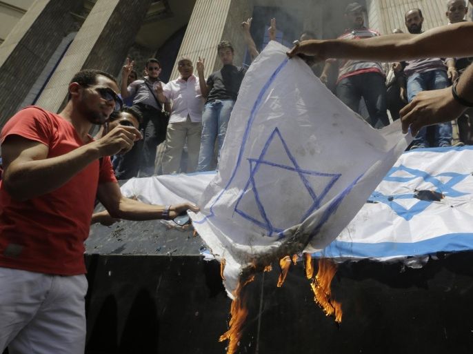 Egyptian journalists burn an Israel flag to protest against the Israeli operations in Gaza, while holding a demonstration in front of the Syndicate of Journalists building in Cairo, Egypt, Sunday, July 13, 2014. Foreign diplomats continued their efforts to end the bloodshed. German Foreign Minister Frank-Walter Steinmeier will fly to Israel for talks Monday and Tuesday with both the Israelis and the Palestinians. Meanwhile, the Arab League will meet Monday to discuss the offensive. (AP Photo/Amr Nabil)
