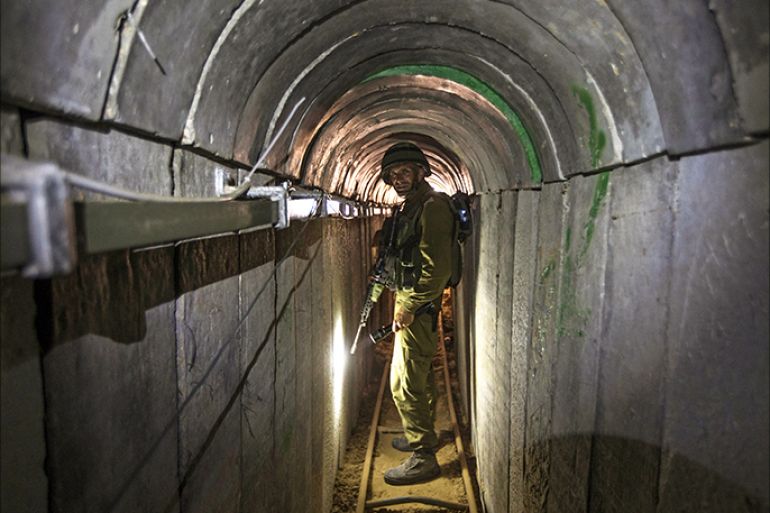epa04330642 An Israeli army officer gives explanations to journalists during an army organised tour in a tunnel said to be used by Palestinian militants for cross-border attacks, at the Israeli-Gaza border, 25 July 2014. Israel launched its military offensive aiming at destroying tunnels used by militants. EPA/JACK GUEZ / POOL