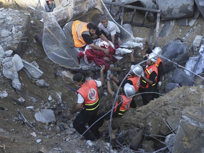 ATTENTION EDITORS - VISUAL COVERAGE OF SCENES OF INJURY OR DEATH Palestinian rescue workers use an excavator to remove a dead body after what witnesses said was an Israeli air strike on the al-Najar family house in Khan Younis in the southern Gaza Strip July 26, 2014. A 12-hour humanitarian truce went into effect on Saturday after Israel and Palestinian militant groups in the Gaza Strip agreed to a U.N. request for a pause in fighting and efforts proceeded to secure a long-term ceasefire moved ahead.The Gaza Health Ministry said 18 members of a single family were killed by Israeli tank shelling in the southern Gaza Strip shortly before the truce took effect at 8 a.m. (6 a.m. British Time). An Israeli military spokeswoman said she was checking the report. REUTERS/Ibraheem Abu Mustafa (GAZA - Tags: POLITICS CIVIL UNREST CONFLICT) TEMPLATE OUT