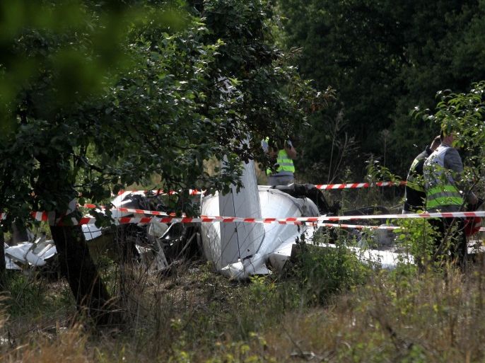 Police officers inspect the plane wreck at the crash site in Topolow, near Czestochowa, southern Poland, 05 July 2014. Eleven people died and one was severely injured when the Piper PA-31 Navajo plane crashed and caught fire. The aircraft, which had taken off only a few minutes earlier from a nearby airfield, apparently carried parachutists, officials said. EPA/WALDEMAR DESKA POLAND OUT