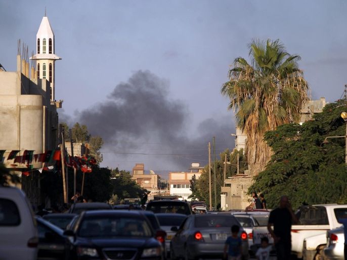 Smoke billows during clashes between security forces and armed groups near a Libyan army special forces barracks, on July 23, 2014, in the eastern city of Benghazi. Elsewhere in the country, rival militias have been engaged in a bloody battle for Libya's main international airport in Tripoli for 11 days that has halted all flights and caused extensive damage to airport infrastructure. AFP PHOTO / ABDULLAH DOMA