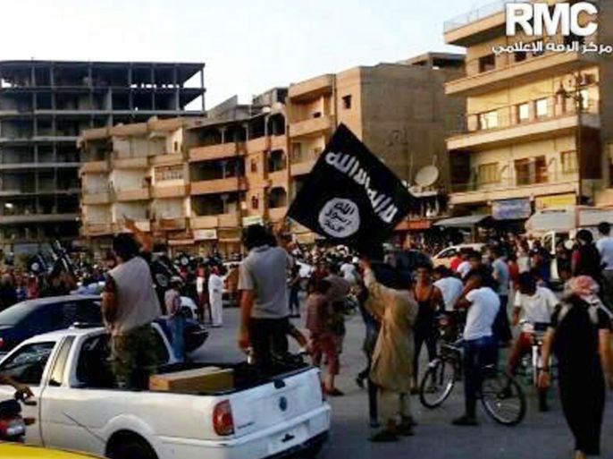 This undated image posted by the Raqqa Media Center, a Syrian opposition group, on Monday, June 30, 2014, which has been verified and is consistent with other AP reporting, shows fighters from the al-Qaida linked Islamic State of Iraq and the Levant (ISIL) during a parade in Raqqa, Syria. Militants from an al-Qaida splinter group held a military parade in their stronghold in northeastern Syria, displaying U.S.-made Humvees, heavy machine guns, and missiles captured from the Iraqi army for the first time since taking over large parts of the Iraq-Syria border. (AP Photo/Raqqa Media Center)