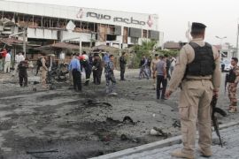 Iraqi security forces inspect the site of a car bomb attack in Basra, southeast of Baghdad, July 5, 2014. At least three people were killed and 15 wounded when two car bomb attacks targeted a restaurant and hotel on Saturday in Basra, southeast of Baghdad, according to hospital sources. REUTERS/Essam Al-Sudani (IRAQ - Tags: CIVIL UNREST POLITICS CRIME LAW CONFLICT)