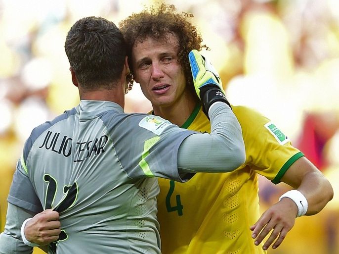 Brazil's defender David Luiz (R) cries as he hugs Brazil's goalkeeper Julio Cesar after they won their match against Chile in a penalty shoot out after extra-time in the Round of 16 football match at The Mineirao Stadium in Belo Horizonte during the 2014 FIFA World Cup on June 28, 2014. AFP PHOTO / MARTIN BERNETTI