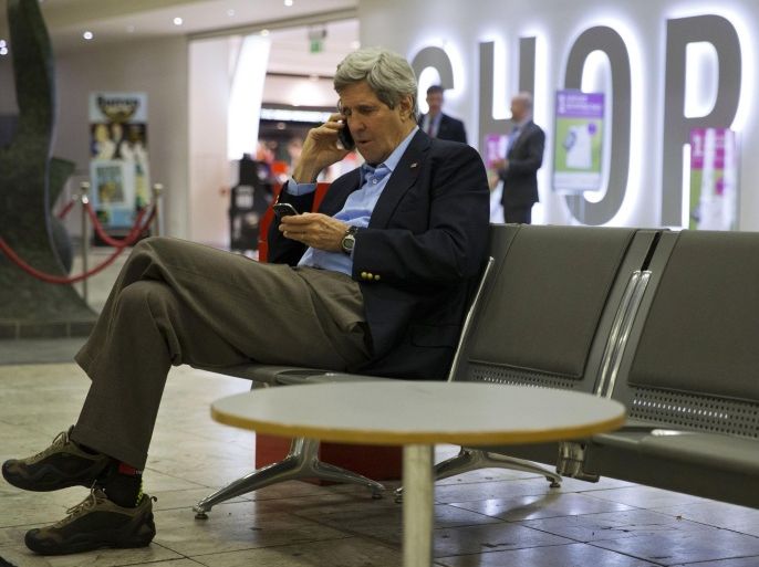 FILE - This March 29, 2014 file-pool photo shows Secretary of State John Kerry speaking on his cell phone at Shannon Airport in Ireland. More than a week into what had been a scheduled five-day trip to Europe and Saudi Arabia, Kerry sat in a Paris hotel suite last Monday morning contemplating his next moves on multiple crisis fronts. Despite a hastily arranged emergency meeting with his Russian counterpart in the French capital the night before, Moscow was still massing troops on Ukraine’s border, apparently threatening invasion, and Kerry’s pet project, the Israeli-Palestinian peace process, was teetering on the brink of collapse. (AP Photo/Jacquelyn Martin, File- Pool)