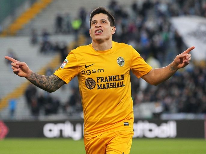 FILE - In this Monday, Jan. 6, 2014 file photo Verona's Juan Manuel Iturbe celebrates after scoring, during a Serie A soccer match between Udinese and Verona at the Friuli Stadium in Udine, Italy. Promising Argentine forward Juan Manuel Iturbe is joining Italian runner-up Roma in a €22 million ($30 million) transfer from Hellas Verona. Roma says the 21-year-old Iturbe signed a five-year deal and the transfer price could reach €24.5 million ($33.2 million) with bonuses related to the Giallorossi's success rate. Iturbe impressed with Verona last season, showing speed with the ball, scoring ability with eight goals and talent on free kicks. At 1.72 meters (5-foot-7) he has been compared to Argentina great Lionel Messi. Three-time defending Serie A champion Juventus had also shown interest in Iturbe. Roma has been busy on the transfer market, having also signed left back Ashley Cole from Chelsea and midfielders Seydou Keita (Valencia), Urby Emanuelson (AC Milan) and Salih Ucan (Fenerbahce). (AP Photo/Paolo Giovannini, File)