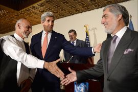 (From L) Afghan presidential candidates Ashraf Ghani, US Secretary of State John Kerry and Afghan presidential candidates Abdullah Abdullah shake hands during a joint press conference in Kabul on July 12, 2014. US Secretary of State John Kerry on July 12 held a second day of talks with Afghanistan's feuding presidential hopefuls, seeking a deal to "clean up the tally" after disputed elections. AFP PHOTO/SHAH Marai