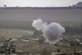 An Israeli artillery fires a 155mm shell towards targets in the Gaza Strip from their position near Israel's border with the Palestinian enclave on July 23, 2014.
