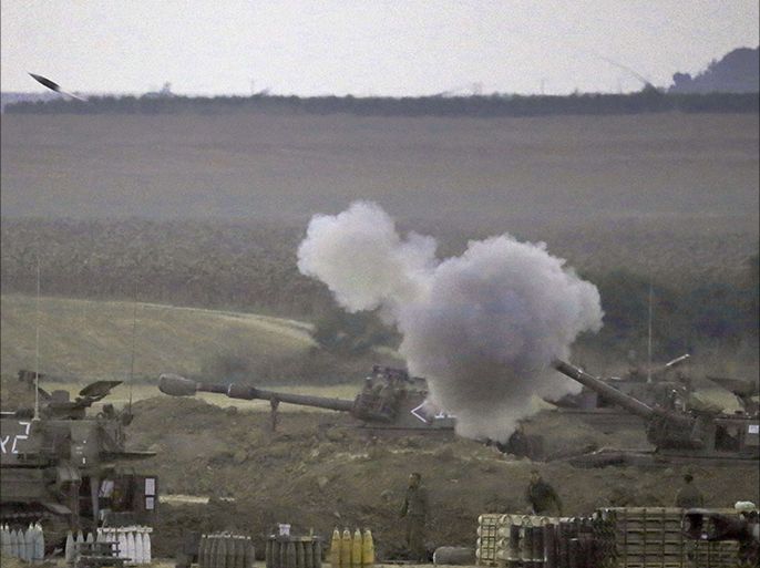 An Israeli artillery fires a 155mm shell towards targets in the Gaza Strip from their position near Israel's border with the Palestinian enclave on July 23, 2014.