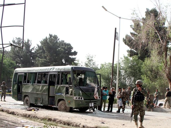 Afghan security officials inspect the scene of a suicide bomb attack, that targeted an Army bus in Kabul, Afghanistan, 02 July 2014. At least four Afghan soldiers were killed in the incident. It was the first attack during the Muslim holy month of Ramadan.