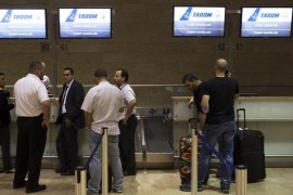 Passengers and airline staff stand near a check-in desk of an airline that cancelled its flight out of Tel Aviv at Ben Gurion International airport July 22, 2014. The Federal Aviation Administration (FAA) banned U.S. carriers from flying to or from Ben Gurion International Airport, after a rocket fired from Gaza struck near the airport's fringes, injuring two people. European airlines including Germany's Lufthansa, Air France and Dutch airline KLM said they were halting flights there too. Israel's flagship carrier El Al continued flights as usual. REUTERS/Siegfried Modola (ISRAEL - Tags: CONFLICT POLITICS CIVIL UNREST TRANSPORT)