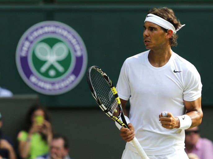 Rafael Nadal of Spain turns towards his coaches as he celebrates winning a point against Nick Kyrgios of Australia during their men's singles match on Centre Court at the All England Lawn Tennis Championships in Wimbledon, London, Tuesday, July 1, 2014. (AP Photo/Ben Curtis)