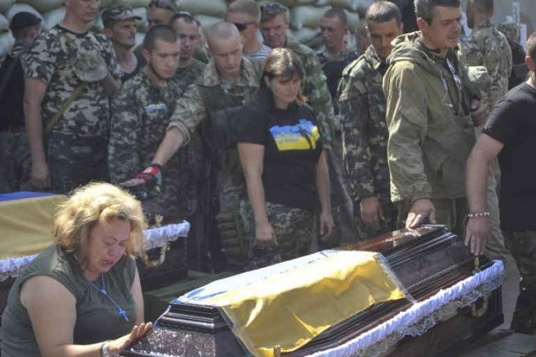 Soldiers of Ukrainian battalion 'Aydar' pay their last respects to fallen colleagues during a funeral ceremony 28 July 2014 in Starobelsk, in the Lugansk area, Ukraine. They were killed during fighting against pro-Russian militants. The Dutch investigators have not able to get to the crash site of the Malaysian Boeing flight MH17 because of fights in the area. Malaysia Airlines Boeing 777 flight MH17 with more than 280 passengers, including 193 Dutch passengers on board crashed in eastern Ukraine on 17 July.