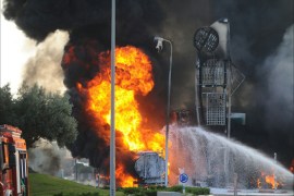 Israeli fire fighters extinguish a blazing fire at a gas station hit by a rocket fired from the Palestinian Gaza Strip, in the city of Ashdod in southern Israel, on July 11,2014