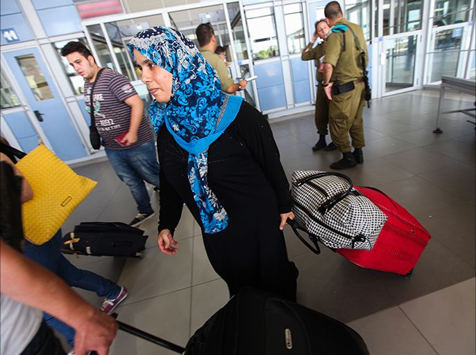 epa04313556 Palestinians with dual citizenship cross from the Gaza Strip into Israel via Erez Crossing, north of Gaza, 13 July 2014. An Israeli airstrike in Gaza City overnight killed 18 people and wounded approximately 50 others, including the commander of the Gaza police force, health officials said. Meanwhile, the Israeli army warned residents in northern Gaza to leave their homes 'for their own safety.' The Israeli military said Hamas militants fired 36 rockets on 12 July, two of which were intercepted by the Iron Dome missile defence system. EPA/ATEF SAFADI