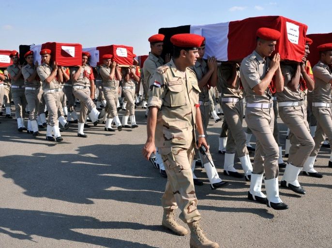 A handout photo made available by the Egyptian Presidency shows Egyptian soldiers carry the coffins of their colleagues who were killed in Farafra, during their funeral at Almaza military airport, Egypt, 20 July 2014. According to media sources those responsible have yet to be identified, but the current President of Egypt, Abdel Fattah al-Sissi, has vowed the attack will not go unanswered and declared three days of mourning for those who lost their lives. EPA/EGYPTIAN PRESIDENCY / HANDOUT EDITORIAL USE ONLY/NO SALES