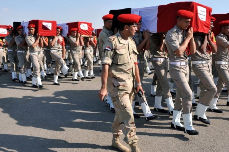 A handout photo made available by the Egyptian Presidency shows Egyptian soldiers carry the coffins of their colleagues who were killed in Farafra, during their funeral at Almaza military airport, Egypt, 20 July 2014. According to media sources those responsible have yet to be identified, but the current President of Egypt, Abdel Fattah al-Sissi, has vowed the attack will not go unanswered and declared three days of mourning for those who lost their lives. EPA/EGYPTIAN PRESIDENCY / HANDOUT EDITORIAL USE ONLY/NO SALES
