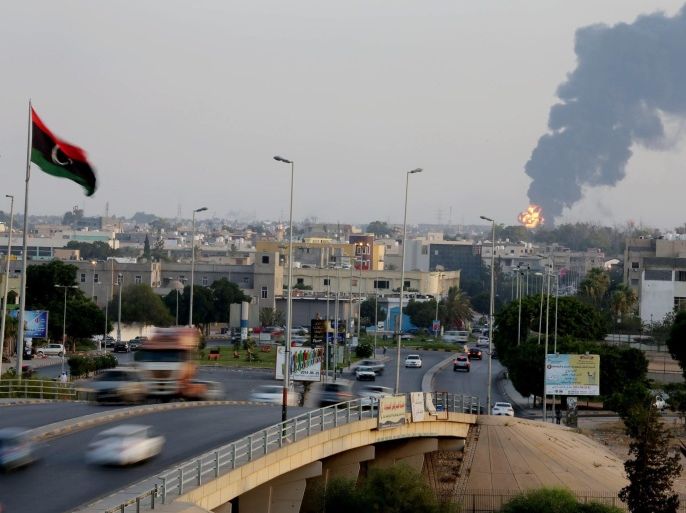 Black smoke billows from a fuel storage depot near the airport in Tripoli, Libya, 28 July 2014, after it was hit by rocket fire. The Libyan government called on rival militias to stop fighting around the Tripoli airport to allow civil defence forces to put out a fire that broke out in oil tankers there. The fire broke out in the tankers when a rocket hit a container containing 6.6 million litres of fuel, al-Wasat news website reported. Overall, the tankers in the warehouse contain 90 million litres of fuel.