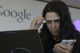 Cecilia Abadie, founder of 33 Labs, uses a pair of Google Glass as she registers for Google I/O 2014 at the Moscone Center in San Francisco, Tuesday, June 24, 2014. (AP Photo/Jeff Chiu)