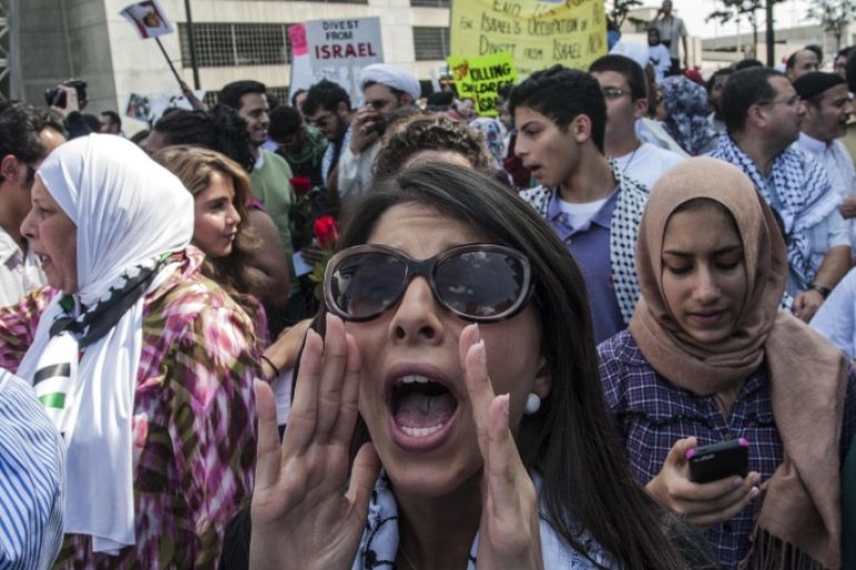 Pro-Palestinian demonstrators chant and yell at pro-Israel demonstrators across the street on Friday, July 25, 2014, in Atlanta, Georgia. (AP Photo/Ron Harris)