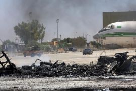 A picture taken on July 16, 2014, shows the remains of a burnt airplane at the Tripoli international airport in the Libyan capital. Tripoli international airport came under rocket fire Wednesday for a fourth straight day, in attacks aimed at ousting anti-Islamist fighters who control the facility, a Libyan security official said. Islamist militias have since Sunday unleashed dozens of rockets at Tripoli airport, damaging around a dozen planes and closing down Libya's main air link with the outside world. AFP PHOTO/MAHMUD TURKIA