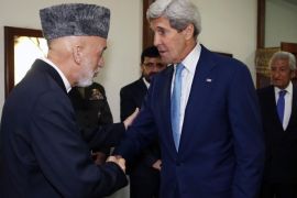 U.S. Secretary of State John Kerry is greeted by Afghanistan's President Hamid Karzai (L) as he arrives for a dinner at the presidential palace in Kabul, July 11, 2014. REUTERS/Jim Bourg (AFGHANISTAN - Tags: POLITICS)